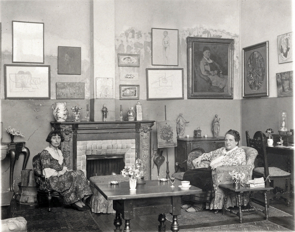 Inside Stein’s home and venue for her Salons at 27 Rue de Fleurus.
Today, our namesake, the writer, art collector and visionary would have been 140 years old. In her time, Gertrude Stein overcame prejudices against her gender, religion and sexuality to become one of the most influential figures in art, building a legendary personal art collection. 
From her home in Paris, the American expatriate gathered some of the greatest minds of the modernist movement at her weekly salons, including Pablo Picasso, Ernest Hemingway, Henri Matisse, or F. Scott Fitzgerald. These salons facilitated a community of visionaries that eventually changed the shape of art as we know it today. They continue to inspire us here at Gertrude. 
2014 will be Gertrude’s year once more. Our team resurfaced the Salon in New York City on December 2nd 2012, and we have been seeing the movement grow dramatically ever since thanks to your unconditional support. This year, we extend to other cities, add new forms of events and access with relentless focus on quality. We will not rest until the art world feels more like a Salon.
Happy 140th birthday, Gertrude.
