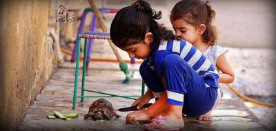 Young Syrian children feed a Free Syrian Tortoise.Even though Syrians are hungry, they look out for each another. Assad is unable to kill Syrians&#8217; resilient spirit of compassion, justice, and honor.
