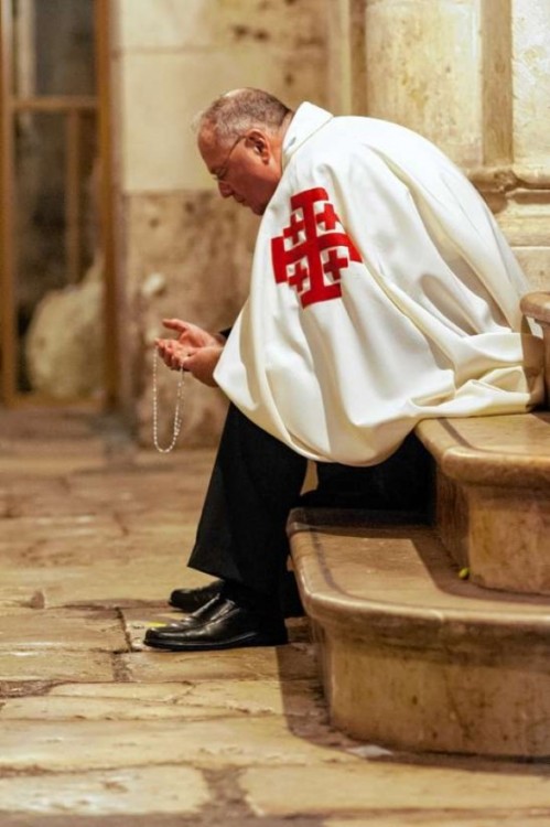 Cardinal Timothy Dolan prays the rosary on steps of the Church of the Holy Sepulchre in Jerusalem while on a pilgrimage to the Holy Land. (January 2012)
Photo: Bob Mullen/The Catholic Photographer