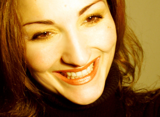 image of woman smiling to show emotions 