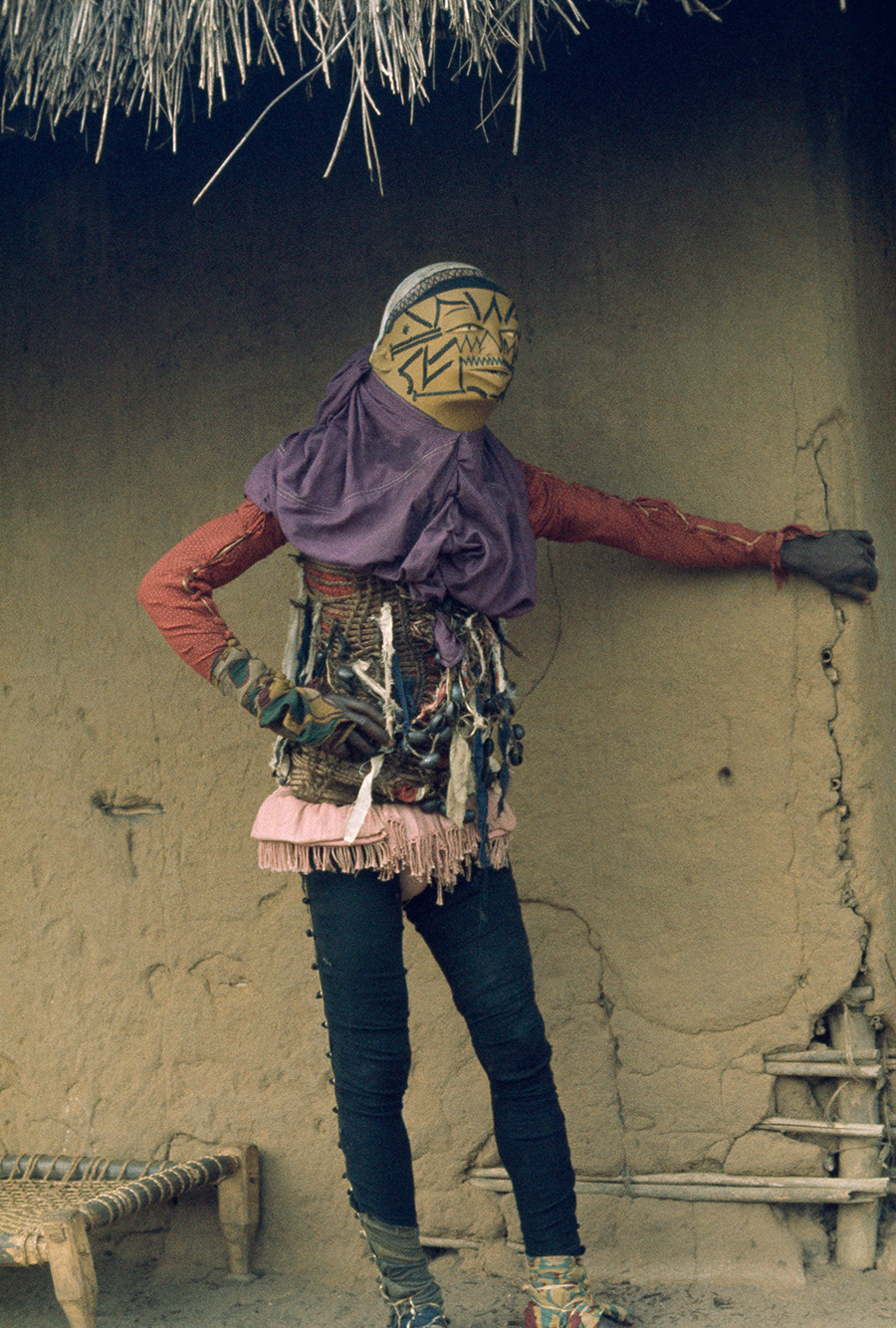 Personifying evil, a costumed mapico dancer in Mozambique hides from spectators, 1964.Photograph by Volkmar K. Wentzel, National Geographic Creative