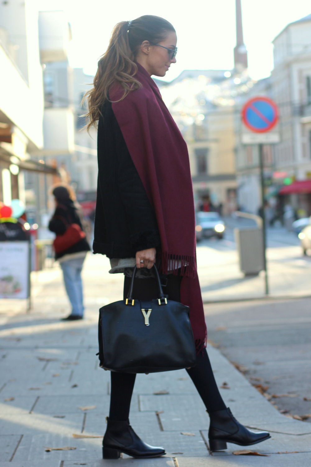 Benedichte is wearing a large burgundy scarf from Creative Collective