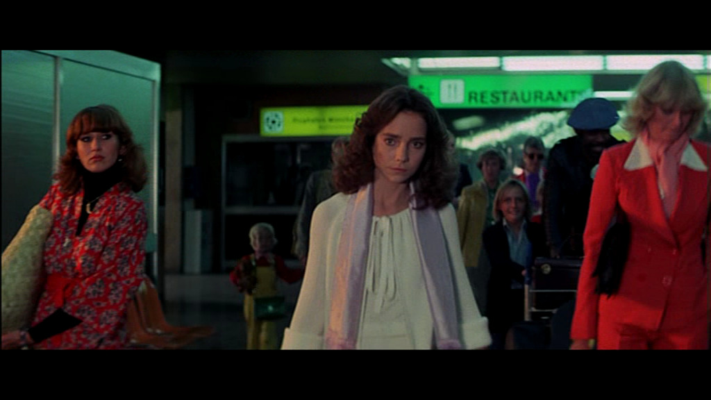 Woman at airport (Daria Nicolodi, left, screenwriter and partner of director) in Suspiria (1977)
