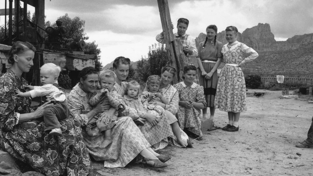 mormonhair:The five wives of Richard S Jessop and several of their children rest in Short Creek Arizona, 1953photo by Joern Gerdts, Getty ImagesRichard Seth Jessop (1894-1978) was Merril Jessop&#8217;s father. He was simultaneously Carolyn Jessop&#8217;s father-in-law and stepgrandfather.Richard Seth Jessop was a son of Joseph Smith Jessop snr. Richard&#8217;s siblings include Uncle Fred, Vergel Yeates Jessop and the AUB&#8217;s Joseph Lyman Jessop snr.  Richard Seth Jessop&#8217;s AGE AT RAID: almost 60 years old.Richard&#8217;s wives were1) Alveda Anderson. Richard&#8217;s first wife Alveda (marriage in 1915) had died in 1927. 2) Ida Young Johnson (1906-1956). Parents: Jeremiah Nelson Johnson &amp; Anna &#8220;Annie&#8221; Maud Young. Marriage in 1928. Jeremiah Johnson was a brother of Leroy S. Johnson and Warren Elmer Johnson (all were sons of Warren Marshall Johnson). AGE AT RAID: 47. Ida was Merril Jessop&#8217;s mother.   3) Fern Judith &#8220;Judy&#8221; Carlson Shapley (1919-1992). AGE AT RAID: 34.4) Lola Spencer Johnson (1916-2012). Parents: Warren Elmer Johnson &amp; Viola Spencer. 14 children. AGE AT RAID: 37. 5) Artemishia &#8220;Mishie&#8221; Spencer Johnson (*1931), spelled &#8220;Artimichie&#8221; in Richard Seth Jessop&#8217;s obituary- for reasons unclear to me she was the legal wife when he died. Parents: Warren Elmer Johnson &amp; Viola Spencer. Children include Ernest Randolph Jessop (1950-1975), died of brain tumor. Mishie was a teenager and Richard Seth was in his 50s years old when he impregnated her. AGE AT RAID: 21 years old.  6) Jennie Johnson Bistline (1902-1984). Widow of John Anthony Bistline, who had died in 1949. Maternal grandmother of Carolyn Bistline Blackmore. John Anthony Bistline died when Carolyn Bistline&#8217;s mother Nurylon Johnson Bistline was only two years old. Nurylon was then raised by Richard Seth Jessop. Which means that Merril Jessop and Carolyn Bistline were uncle and niece by marriage&#8230; and that Merril Jessop and his later mother-in-law Nurylon Bistline had been raised as siblings. Similarly, Jennie&#8217;s son and Nurylon&#8217;s brother Ben Bistline (the author) married his stepsister (Merril&#8217;s full sister) Annie Johnson Jessop. Jennie Johnson was not closely related to her sisterwives Ida Johnson and Ida&#8217;s cousins Mishie and Lola Johnson. Jennie was a great-granddaughter of Benjamin F. Johnson. AGE AT RAID: 51 years old.In the picture above, Jennie is definitely the second from left. Ida is the woman at the far right. Mishie and her full sister Lola Spencer Johnson are between Jennie and Ida. Which would make the woman in the front Fern Carlson.More pictures of Richard Seth Jessop&#8217;s family during the Short Creek raid: Two of the wives of Richard Seth Jessop are also featured on the right here, all 5 wives and the children are also here and the wife on the far left of the picture above (probably Fern Carlson) is also in this picture here.     