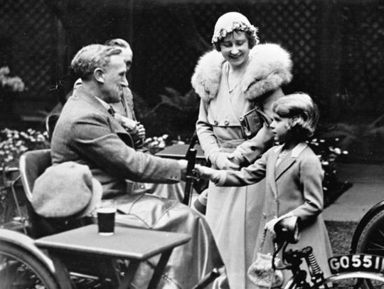 Britain's Princess Elizabeth, later to become Queen Elizabeth II, is introduced by her mother, the Duchess of York, to disabled soldiers at an exhibition of their work in London, May 16, 1933. (AP)