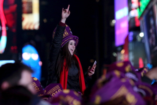 A woman cheers during New Year celebrations in Times Square in the Manhattan borough of New York December 31, 2015. REUTERS/Andrew Kelly