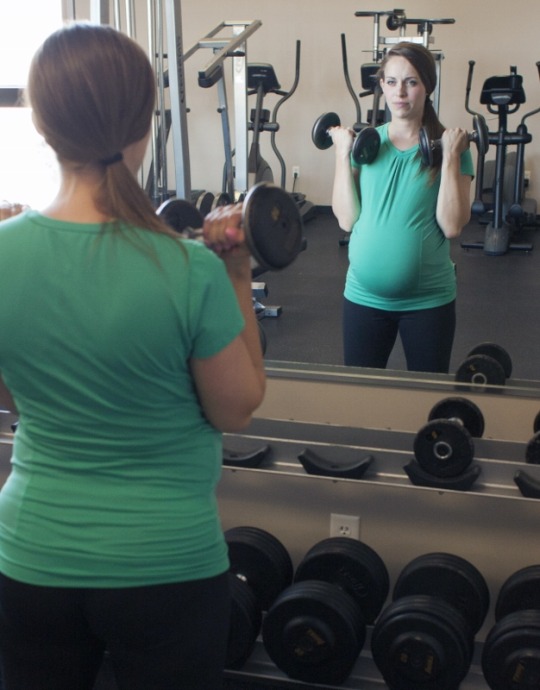 woman working out during pregnancy in supportive maternity clothes