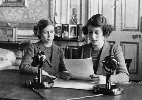 14-year-old Princess Elizabeth, right, is shown sitting with her younger sister, Princess Margaret Rose, before her first radio broadcast in 1940. (AP)