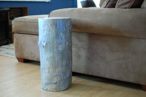 Silver Reclaimed Wood Stump Table - Only one available - This maple tree stump is where rustic and snazzy meet in the middle. Great to be used as a side table, end table or just as a piece to add some rustic flair to the living room. The stump has been sanded, sealed and sprayed with silver and then sanded down again to bring out the texture of the wood beneath it. We left the top natural to bring out the rustic-ness of the wood stump. Dimensions: 21&#8221; T x 10&#8221; W
Purchase here.