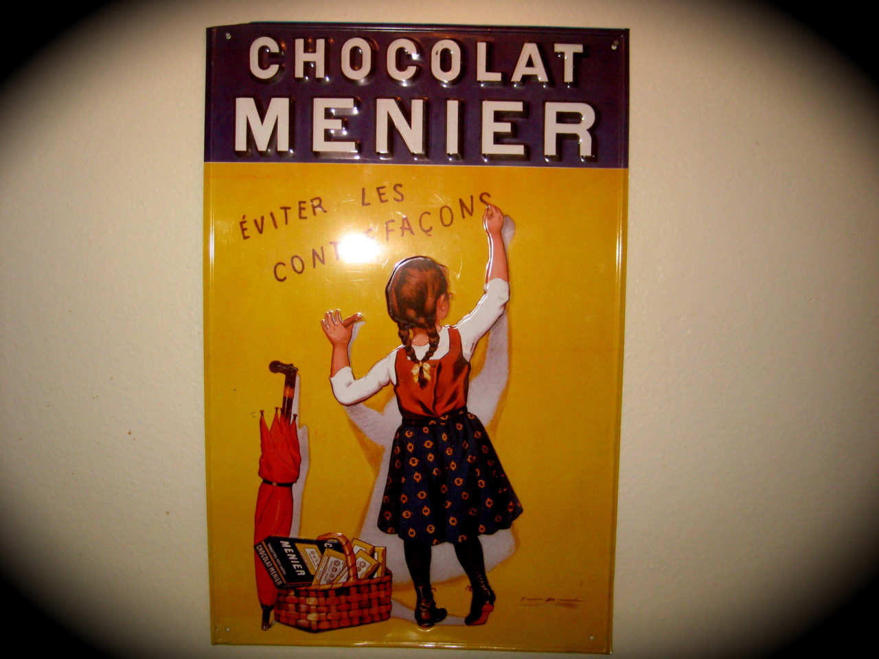 This ad for a now defunct chocolate company is the newest addition to my kitchen.
I don&rsquo;t speak French, but I understand that this little girl and I will both be undone by our love of sweets.
Curse you, candies!!!!!
